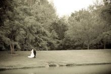 Bride & Groom walking beside lake at New Harmony Inn